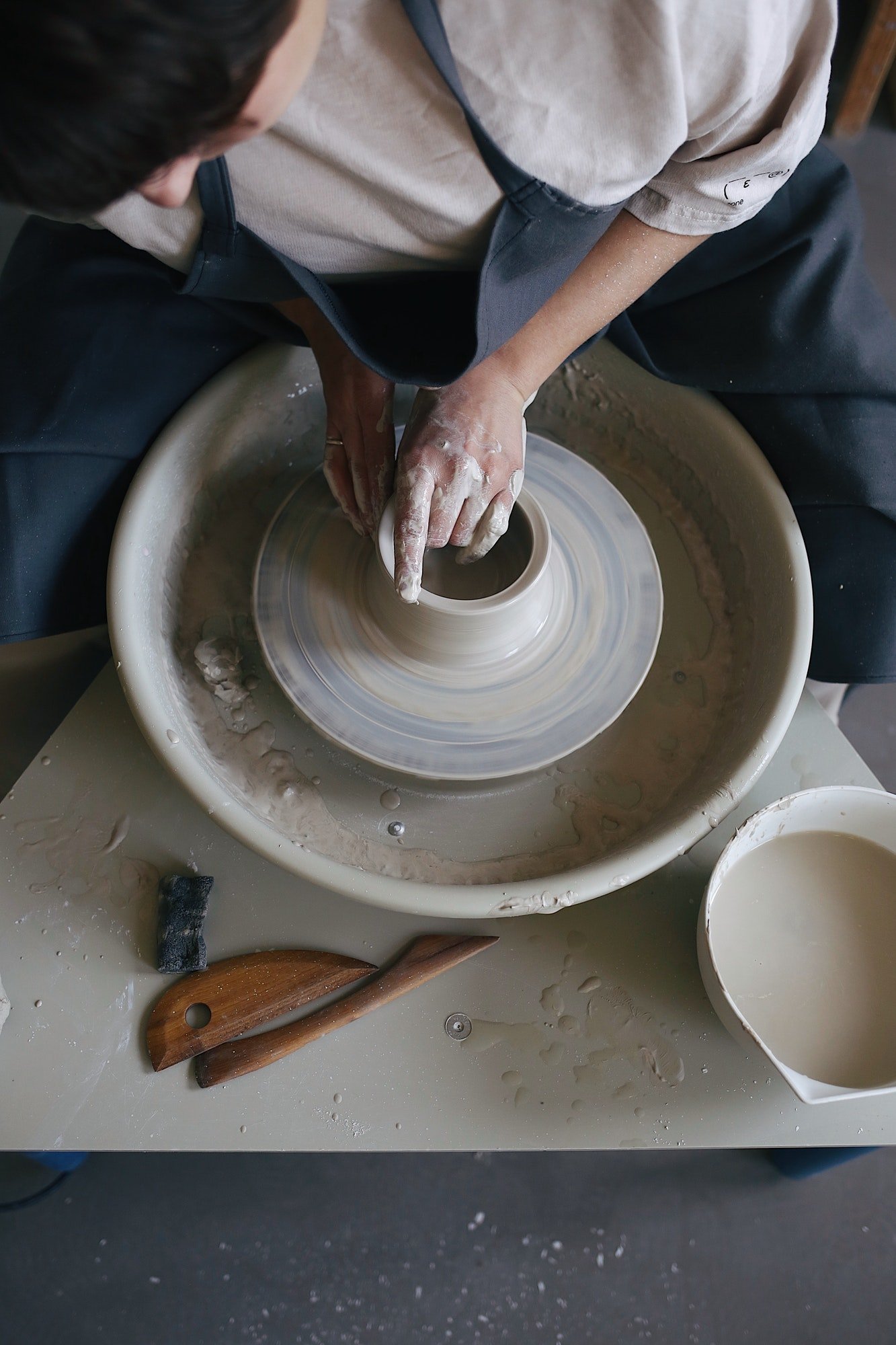 working-on-a-potter-s-wheel-with-a-clay-in-a-pottery-studio-clay-jug.jpg